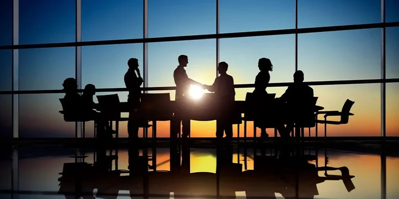 A group of people sitting around a table.