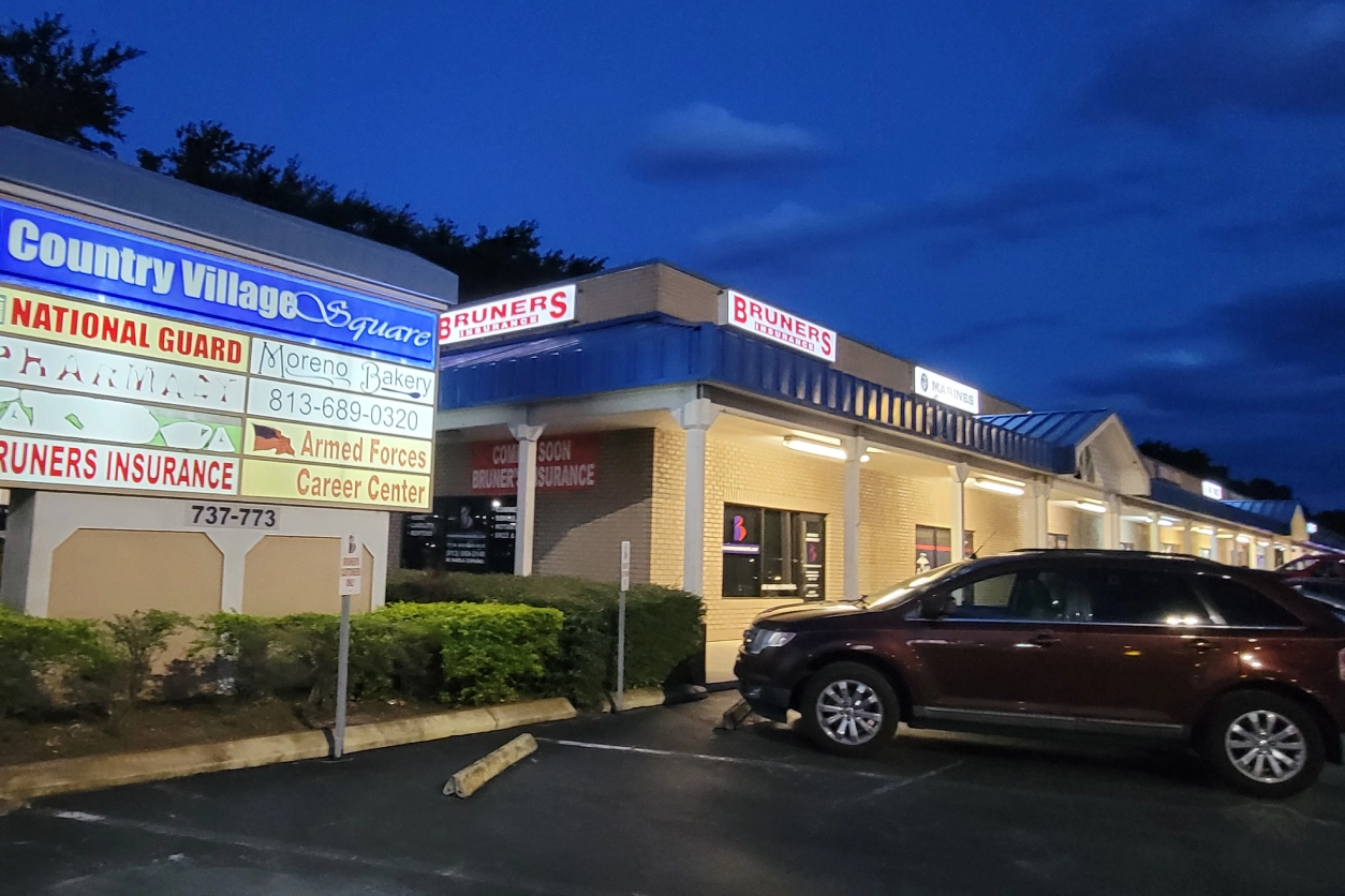 A car parked in front of a store.