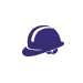 A blue hard hat is sitting in the middle of a green background.