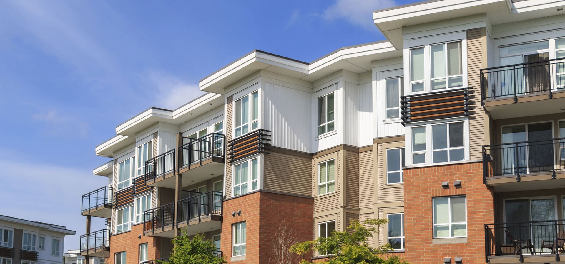 A building with many windows and balconies on the side.